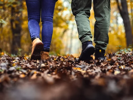 Two friends walking side by side in a park, symbolizing connection, support, and companionship.